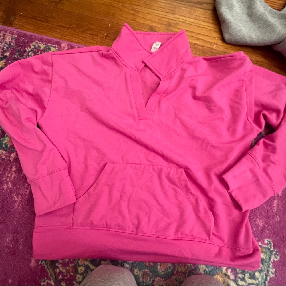 Pink pullover, athletic wear.